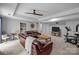 Finished basement living room with comfortable seating, neutral decor, ceiling fan, and carpet flooring at 27 Heritage Ct, Lake Wylie, SC 29710