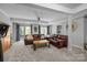 Finished basement living room with sliding glass doors to the outside, comfortable seating and neutral decor at 27 Heritage Ct, Lake Wylie, SC 29710