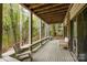 Spacious, covered patio surrounded by natural beauty and outdoor seating at 27 Heritage Ct, Lake Wylie, SC 29710