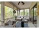 Relaxing screened-in porch with comfortable seating, offering a peaceful retreat and a view of the lush outdoors at 27 Heritage Ct, Lake Wylie, SC 29710