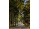 Scenic street view leading to a charming home, surrounded by lush trees at 27 Heritage Ct, Lake Wylie, SC 29710