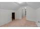 Attic room has unfinished floors and an angled ceiling with exposed rafters at 28120 Ryan Rd, Richfield, NC 28137