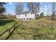 Exterior shot of a home's backyard, showcasing the large lawn and structure at 28120 Ryan Rd, Richfield, NC 28137