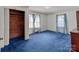 Bedroom featuring wood closet, soft carpet, and natural light from two windows at 28120 Ryan Rd, Richfield, NC 28137