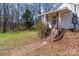 Exterior view of a home with a weathered front entrance and rustic wooden steps at 28120 Ryan Rd, Richfield, NC 28137