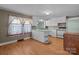 Cozy kitchen featuring white cabinets, wood floor, and a breakfast bar at 28120 Ryan Rd, Richfield, NC 28137
