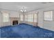 Inviting living room with a classic fireplace and cozy blue carpet at 28120 Ryan Rd, Richfield, NC 28137