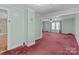 The living room features light green walls and red carpet, with doorways leading to other rooms at 28120 Ryan Rd, Richfield, NC 28137