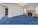 The living room offers a brick fireplace and a cozy blue carpet at 28120 Ryan Rd, Richfield, NC 28137