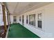 Charming front porch with green carpeting, offering curb appeal and a welcoming entrance at 28120 Ryan Rd, Richfield, NC 28137