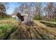 Outdoor view of a property with a metal storage structure and natural surroundings at 28120 Ryan Rd, Richfield, NC 28137