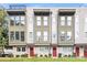 Charming townhome featuring a covered entry and lush landscaping, perfect curb appeal at 327 Uptown West Dr, Charlotte, NC 28208