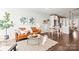 Bright, open-concept living room featuring a comfortable leather couch, modern decor, and hardwood floors at 327 Uptown West Dr, Charlotte, NC 28208