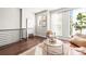 Upstairs sitting area bathed in light from the large windows. Cozy chair and hardwood floors create a welcoming spot at 327 Uptown West Dr, Charlotte, NC 28208