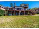 Spacious home with a brick facade, multiple decks, garage, and lush green lawn at 343 River Haven Dr, Taylorsville, NC 28681