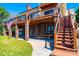 Brick home featuring multi-level patios with stairs, a picnic table, and an American flag at 343 River Haven Dr, Taylorsville, NC 28681