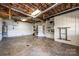 Unfinished basement with white concrete walls, built-in shelving, access to the main house, and concrete flooring at 343 River Haven Dr, Taylorsville, NC 28681
