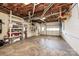 Unfinished basement with visible insulation, utility systems, storage shelves, and access to a garage door at 343 River Haven Dr, Taylorsville, NC 28681