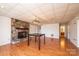 Cozy basement area with hardwood floors, a fireplace with stone surround, and a vintage light fixture at 343 River Haven Dr, Taylorsville, NC 28681