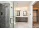 Modern bathroom featuring a glass-enclosed shower and double vanity with gray cabinets and stone countertops at 343 River Haven Dr, Taylorsville, NC 28681