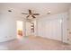 Bright bedroom with neutral carpet, ceiling fan, and ensuite bathroom, providing a comfortable and serene living space at 343 River Haven Dr, Taylorsville, NC 28681