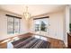 Dining area with chandelier, hardwood floors, and glass doors leading to the deck at 343 River Haven Dr, Taylorsville, NC 28681