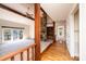 Hallway featuring hardwood floors, exposed beams, and stone fireplace feature at 343 River Haven Dr, Taylorsville, NC 28681