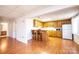 Basement kitchen featuring wood cabinets, a breakfast bar with seating, and basic appliances at 343 River Haven Dr, Taylorsville, NC 28681