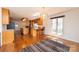 Open-concept kitchen and dining area with hardwood floors, wood cabinetry, and stylish chandelier lighting at 343 River Haven Dr, Taylorsville, NC 28681