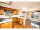 Bright kitchen boasts wood cabinets, sleek countertops, and a breakfast bar with hardwood flooring and lake views at 343 River Haven Dr, Taylorsville, NC 28681