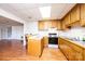 Basement kitchen featuring wood cabinets and appliances with a view to additional living space at 343 River Haven Dr, Taylorsville, NC 28681