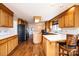 Spacious kitchen featuring wood cabinets, a center island with seating, and modern appliances, with hardwood floors at 343 River Haven Dr, Taylorsville, NC 28681