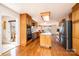 The kitchen has stainless steel appliances, wood cabinets, a center island, and hardwood floors with deck access at 343 River Haven Dr, Taylorsville, NC 28681