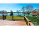 Beautiful lake view from the home's deck with wooden railing overlooking green lawn at 343 River Haven Dr, Taylorsville, NC 28681
