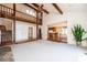 Open-concept living room with exposed beams and clear view into the kitchen at 343 River Haven Dr, Taylorsville, NC 28681
