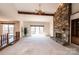 Spacious living room featuring a stone fireplace and sliding glass doors to the deck at 343 River Haven Dr, Taylorsville, NC 28681