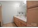 Bathroom with wood cabinets, double sinks and a large mirror at 3939 Picasso Ct, Charlotte, NC 28205
