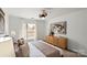 Bright bedroom with a ceiling fan, neutral carpet, a large window, and a wooden dresser at 3939 Picasso Ct, Charlotte, NC 28205