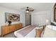 Comfortable bedroom with a ceiling fan, soft carpet, a dresser, and a large window at 3939 Picasso Ct, Charlotte, NC 28205