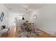 Dining area featuring hardwood floors, modern decor, and an open floorplan leading to the kitchen at 3939 Picasso Ct, Charlotte, NC 28205