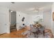 Dining area with hardwood floors, modern decor, a bench and an open floorplan leading to stairs and kitchen at 3939 Picasso Ct, Charlotte, NC 28205
