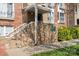Brick building entrance with stairs, a small awning, and mature landscaping at 3939 Picasso Ct, Charlotte, NC 28205