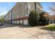 Multi-story apartment building with private garage entrances at 3939 Picasso Ct, Charlotte, NC 28205