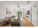 Bright living room with hardwood floors, modern ceiling fan, neutral decor, and balcony access at 3939 Picasso Ct, Charlotte, NC 28205