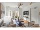 Bright living room with hardwood floors, modern decor, ceiling fans, and a sliding door to the outside at 3939 Picasso Ct, Charlotte, NC 28205