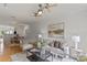 Bright open-concept living room with hardwood floors, modern decor, ceiling fans, and connecting dining area at 3939 Picasso Ct, Charlotte, NC 28205