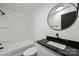 Modern bathroom featuring a granite vanity, updated fixtures, and a tub-shower combination at 450 Tot Dellinger Rd, Cherryville, NC 28021