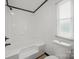 Bright bathroom features white tiled walls, a tub-shower combination, and a modern toilet at 450 Tot Dellinger Rd, Cherryville, NC 28021