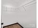 Walk-in closet with installed wire shelving and wood-look floors at 450 Tot Dellinger Rd, Cherryville, NC 28021