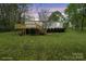 Charming home with a large deck, well-maintained lawn, and mature landscaping at twilight at 450 Tot Dellinger Rd, Cherryville, NC 28021